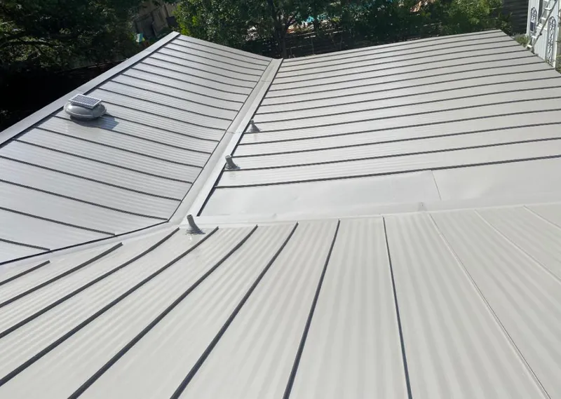 Solar attic fan installed on a metal roof for Roof Ventilation in Raymondville